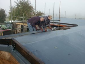 Stable roof showing membrane and Barge Board being installed